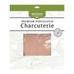 Premium Portuguese charcuterie package with a pale pink rectangular slice of cured meat visible in the center, green top banner labeled 'Delicias' and decorative waves in the background.