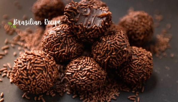 Pile of chocolate brigadeiro truffles covered in chocolate sprinkles on a dark surface, with a 'Brazilian Recipe' watermark in the corner.
