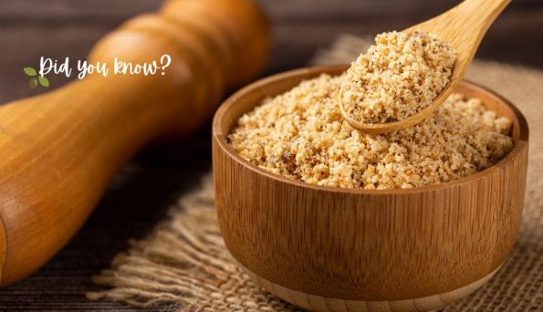 Wooden bowl of brown sugar with a wooden scoop and the text 'Did you know?' in the corner, on a rustic surface.
