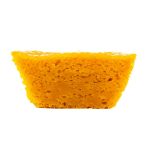 Queijada de Cenoura - Delícias Slice of bright orange sponge cake with airy crumb on a white background, shown from the side.