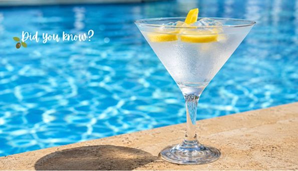 Cocktail glass with ice and lemon wedges on a poolside surface, next to a blue swimming pool, with 'Did you know?' text.