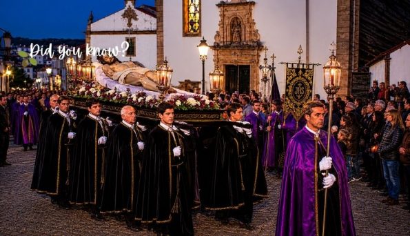 Catholic funeral procession at dusk with pallbearers in black robes carrying a flower-covered bier, led by a priest in purple vestments and onlookers nearby.