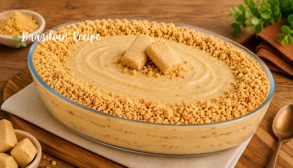 Creamy dessert in a glass dish with a crumb crust rim and two shortbread cookies on top; watermark reads 'Brazilian Recipe'.