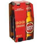 Four 33 cl bottles of Super Bock beer in a red cardboard six-pack carrier labeled 'SUPER BOCK'