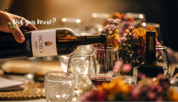 Hand pouring red wine into a glass at a candlelit dinner table with a floral centerpiece; overlay text says 'Did you know?'