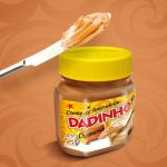 Jar of creamy peanut butter with a yellow lid and a knife spreading peanut butter on top; label reads 'Dadinho' with a bright orange background.