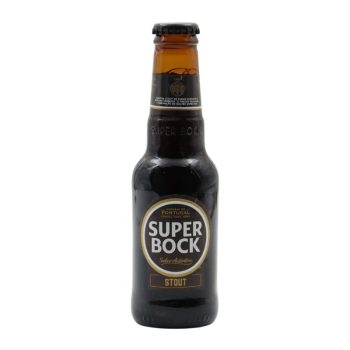 Brown glass bottle of Super Bock Stout beer with a gold-and-black label on a white background, cap on top and condensation visible on the bottle edge.