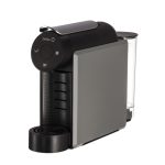 Compact single-serve coffee machine with a right-side water reservoir and a front drip area.