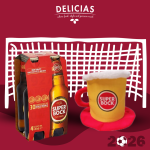 Delicias advertisement showing a six-pack of Super Bock beer bottles beside a frothy beer mug against a white lattice backdrop.