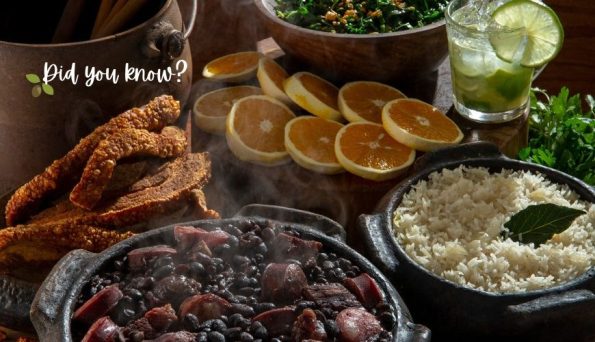 A rustic table with a feast: beans stew in a pot, fried meat, white rice, orange slices, a lime drink, and fresh herbs; overlay text reads 'Did you know?'