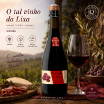 Bottle of red wine with cork stopper and label O tal vinho da Lixa, beside a filled wine glass, vineyard backdrop, branding and cheese spread visible.