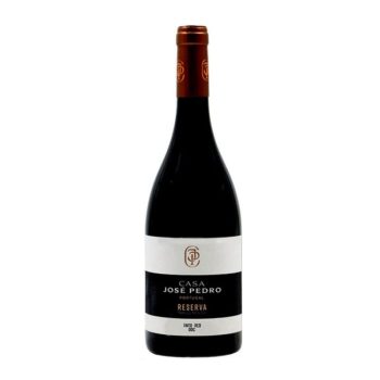 Bottle of Casa Pedro Reserva red wine from Portugal with copper foil capsule and white/black label on a white background.