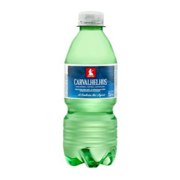 Green plastic bottle of Carvalhelhos natural mineral water with a blue label and white cap.