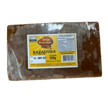 Brown rectangular rapadura block wrapped in clear plastic with a yellow label reading Sitio Peixotos and 650 g.